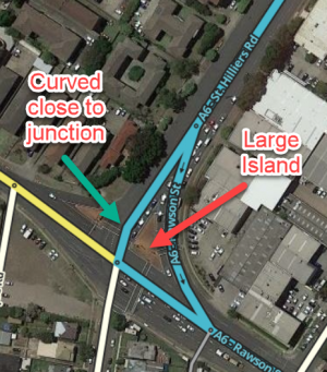 Screenshot illustrating an AGC with a large island and curvature of a main road close to the junction.